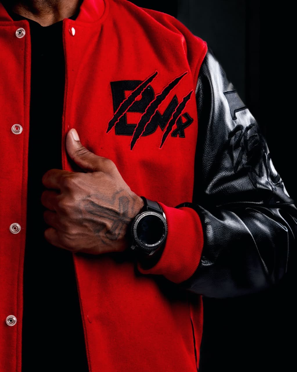 Close-up brand detail of a red and black Beast Mode varsity jacket